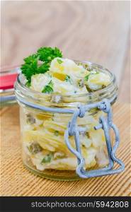 Potato salad in a jar on wooden. Potato salad in a jar on wooden.