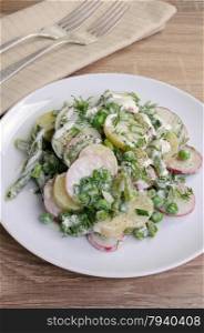 Potato salad with radishes, peas, beans in yogurt dressing