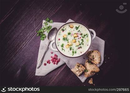 Potato soup with ham, croutons and bread
