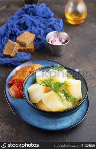 potato with fish and bread on a table