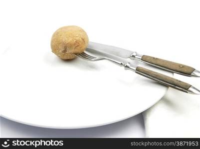 Potato with peel on table