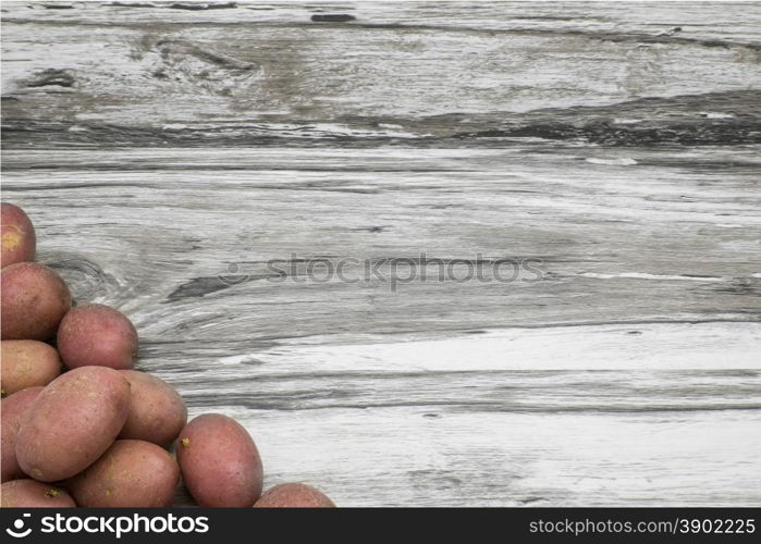 Potatoes on a gray wooden background.