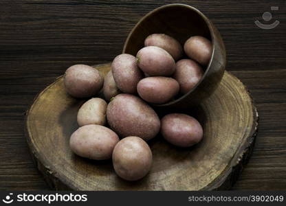 Potatoes on a rustic wooden background.