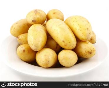 Potatoes on plate. Potatoes arranged on a white plate towards white background