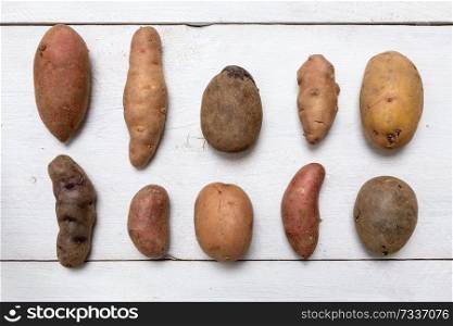 Potatoes on white wooden board Concept.. Potatoes on white wooden board Concept