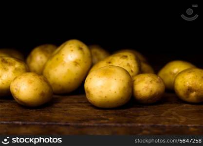 potatoes on wooden surface