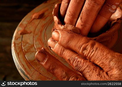 pottery craftmanship red clay potter hands work finger closeup