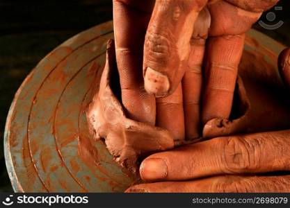 pottery craftmanship red clay potter hands work finger closeup