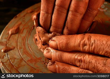 pottery craftmanship red clay potter hands work finger closeup