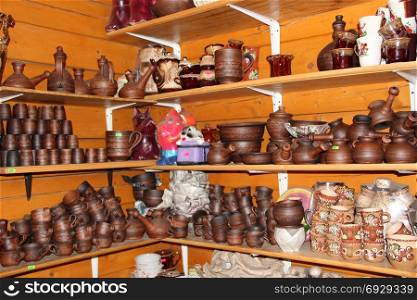 pottery on the shelves of the gift shop. earthenware on the shelves of pottery shop