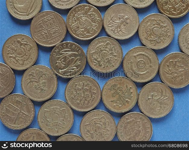 Pound coins, United Kingdom over blue. One Pound coins money (GBP), currency of United Kingdom over blue background
