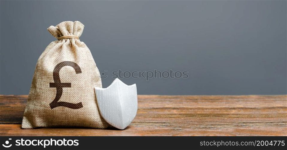 Pound sterling money bag and metal shield. Guaranteed protection of foreign investment in economy. Attractive business conditions, rule of law, secure private capital. Ease of doing business