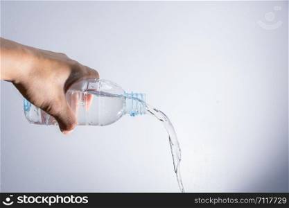 Pour water out of the bottle