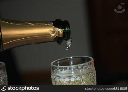 Pouring a glass of sparkling champagne for New Year