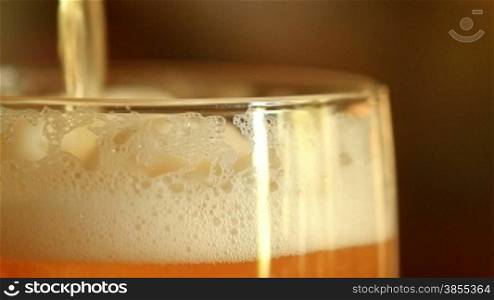 Pouring beer into a glass. close up.