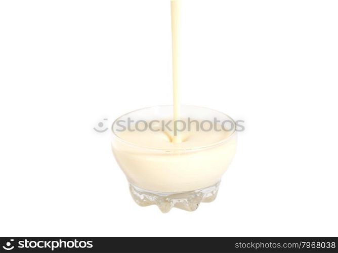 Pouring condensed milk with sugar in glass bowl isolated on white