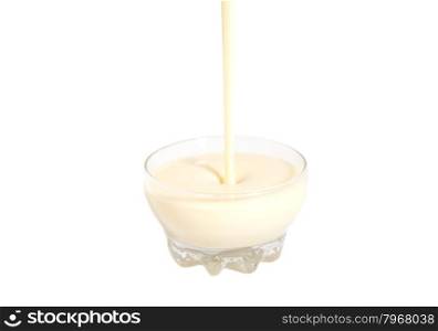 Pouring condensed milk with sugar in glass bowl isolated on white