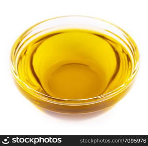 Pouring cooking oil a small glass cup isolated on white background