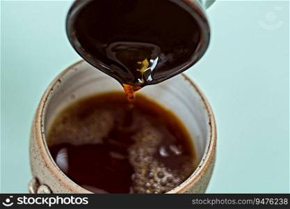 Pouring Drip coffee into a cup,selective focus. . Pouring Drip coffee into a cup