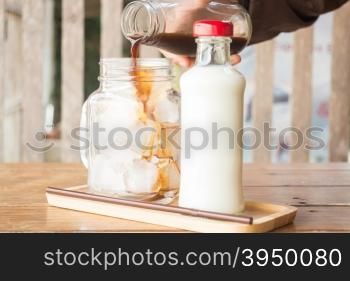 Pouring espresso to iced glass of coffee, stock photo