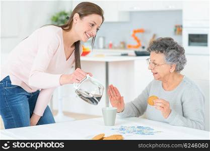 Pouring old lady a coffee
