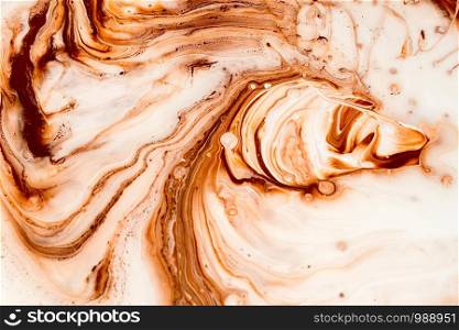Pouring paint of brown color mix with white, making wall paint.