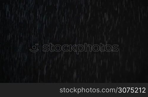 Pouring rain and falling snow, real shot at dark night