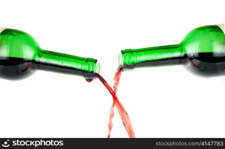 Pouring red wine from two bottle isolated on white background