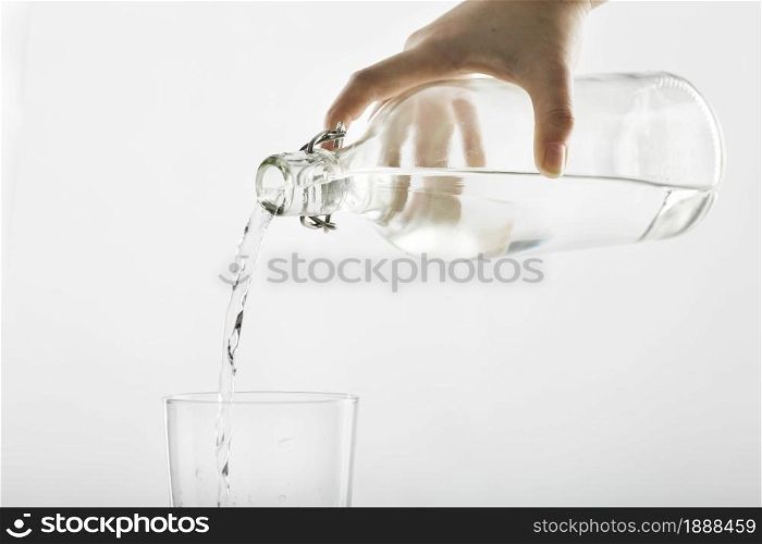 pouring water from bottle into glass . Resolution and high quality beautiful photo. pouring water from bottle into glass . High quality and resolution beautiful photo concept