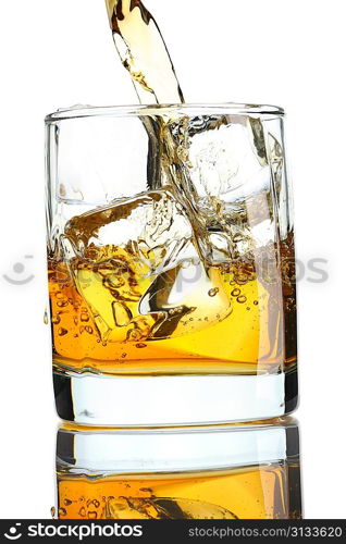 Pouring whiskey in glass with ice isolated on white