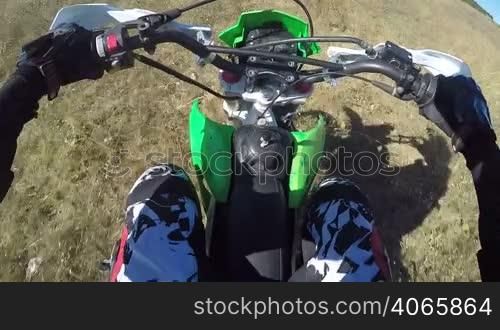 PoV: Enduro racer in motorcycle protective gear riding dirt bike off-road action camera mounted on the chest