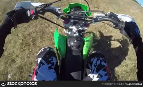 PoV: Enduro racer in motorcycle protective gear riding dirt bike off-road action camera mounted on the chest