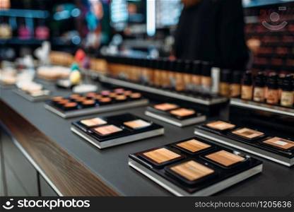 Powders collection, showcase in beauty shop closeup, nobody. Makeup products in store, cosmetic department. Powders collection, showcase in make-up shop