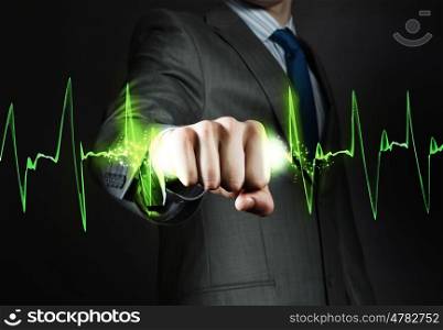Power and control. Close up of businessman hand clenching graph in fist