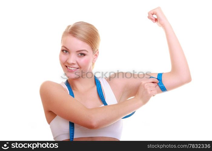 Power and energy. Health care and healthy active lifestyle. Young fitness woman fit girl with measure tape measuring her biceps isolated on white