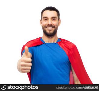 power and people concept - happy man in red superhero cape showing thumbs up over white. happy man in red superhero cape showing thumbs up