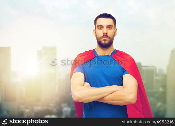 power and people concept - man in red superhero cape over city background. man in red superhero cape over city background
