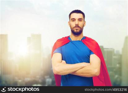 power and people concept - man in red superhero cape over city background. man in red superhero cape over city background