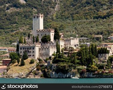 Power boat off the coast of Malcesine on Lake Garda with the castle framing the town