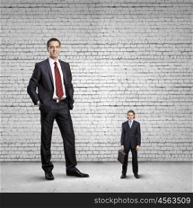 power in business. Big bossy businessman looking down at small businessman