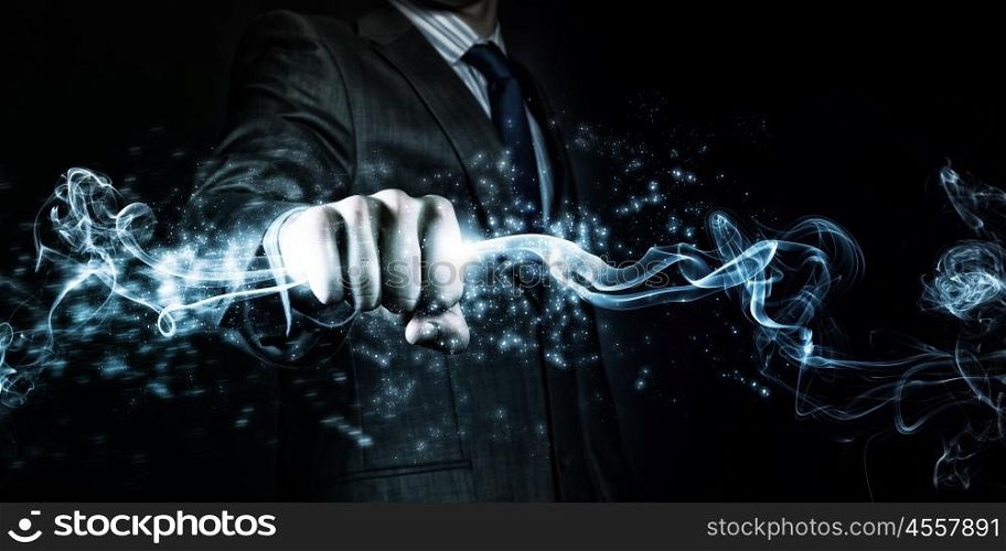 Power in hands. Businessman holding fire flames in fist. Power and control