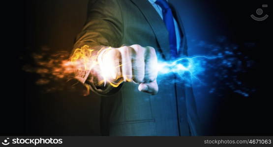 Power in hands. Businessman holding fire flames in fist. Power and control