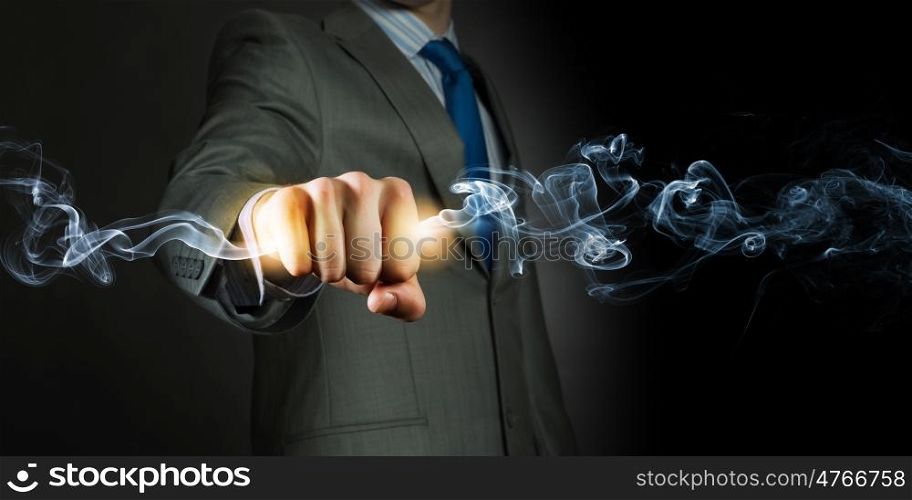 Power in hands. Businessman holding fire flames in fist. Power and control