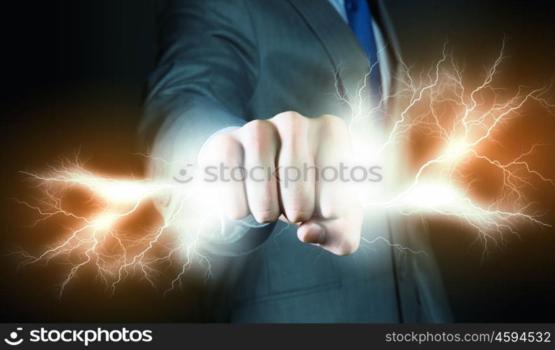 Power in hands. Businessman holding lightning in fist. Power and control