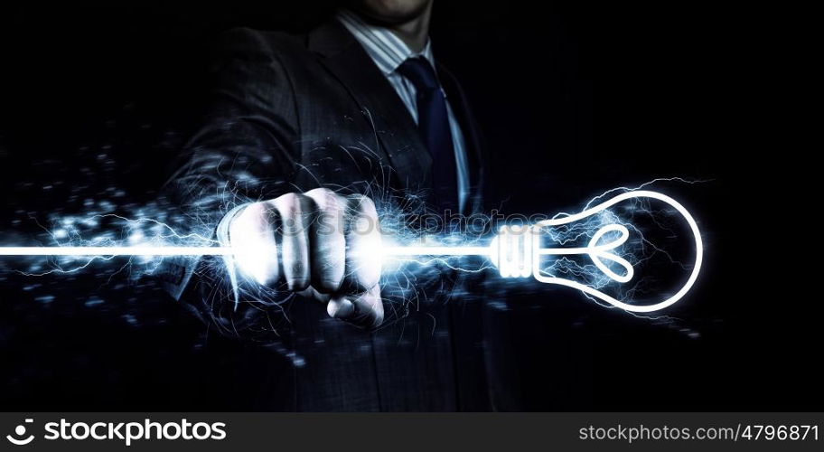 Power in hands. Businessman holding lightning in fist. Power and control