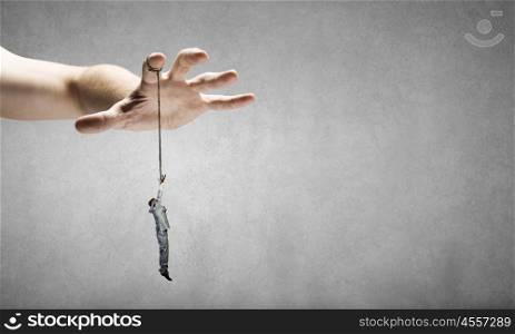Power in hands. Close up of human hand and people hanging on fingers