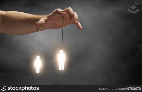 Power in hands. Close up of human hand and people hanging on fingers