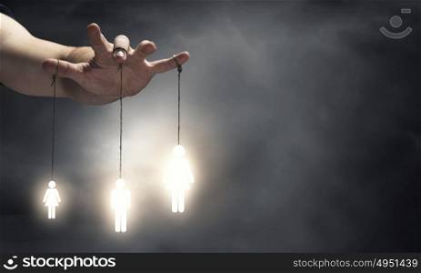 Power in hands. Close up of human hand and people hanging on fingers