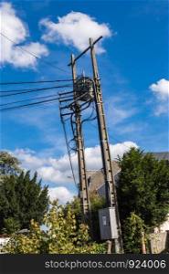 Power line concrete pole end with cables falling vertically. Power Line Concrete Pole End with Vertically Falling Cables and a Height Transformer