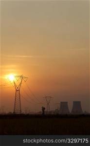 Power line of a nuclear power station; sunset.